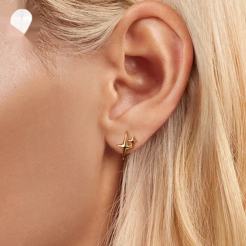 Sterling silver minimalist star ear clips with oxidised finish and XINGX symbol design