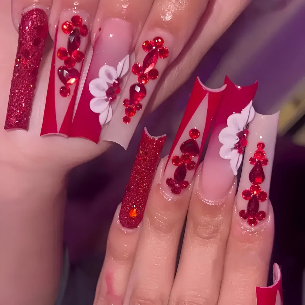 Artificial nails with red floral pattern and prismatic diamond decorations in long square shape