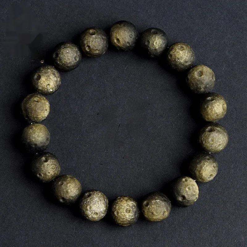 Natural obsidian crater ball bracelet with hand-ground meteorite beads in gold or silver colour options
