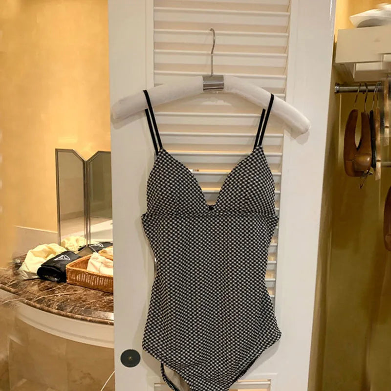 Blue one-piece swimsuit with ruched chest detail and adjustable straps for belly coverage.