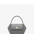 Brown leather wing-shaped tote bag with a buckle detail and latch closure, shown with a single cross-body strap.