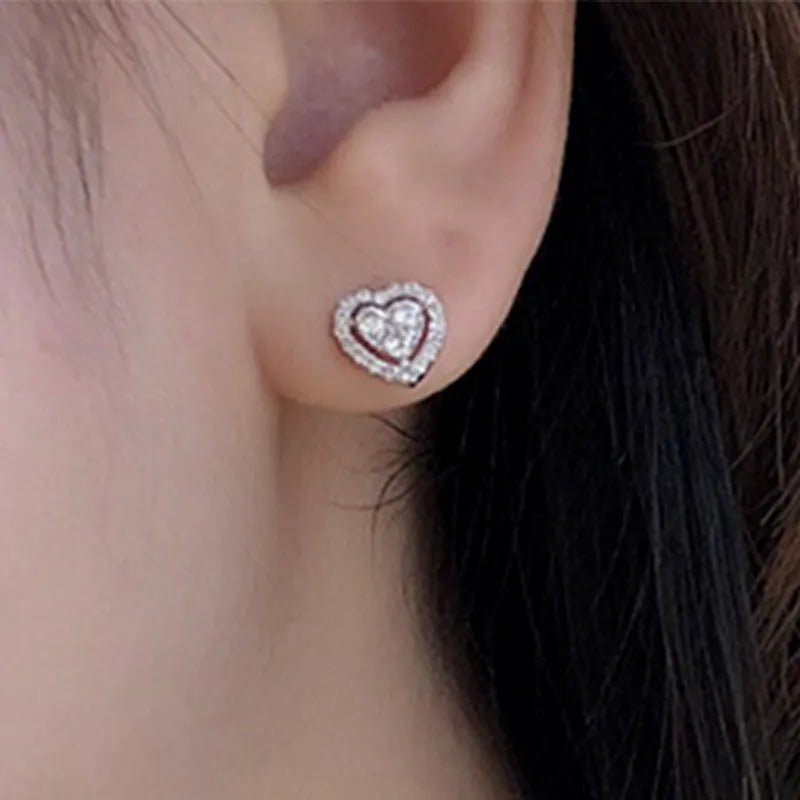 White zircon heart stud earrings with electroplated finish, post-back closure, compact design