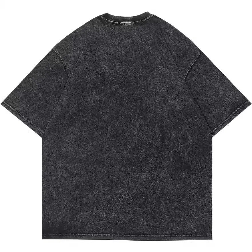 Man wearing a loose black cotton t-shirt with a retro cartoon print on the front.