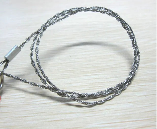 Stainless steel survival wire saw with thumb rings, extended to show its 70cm length.