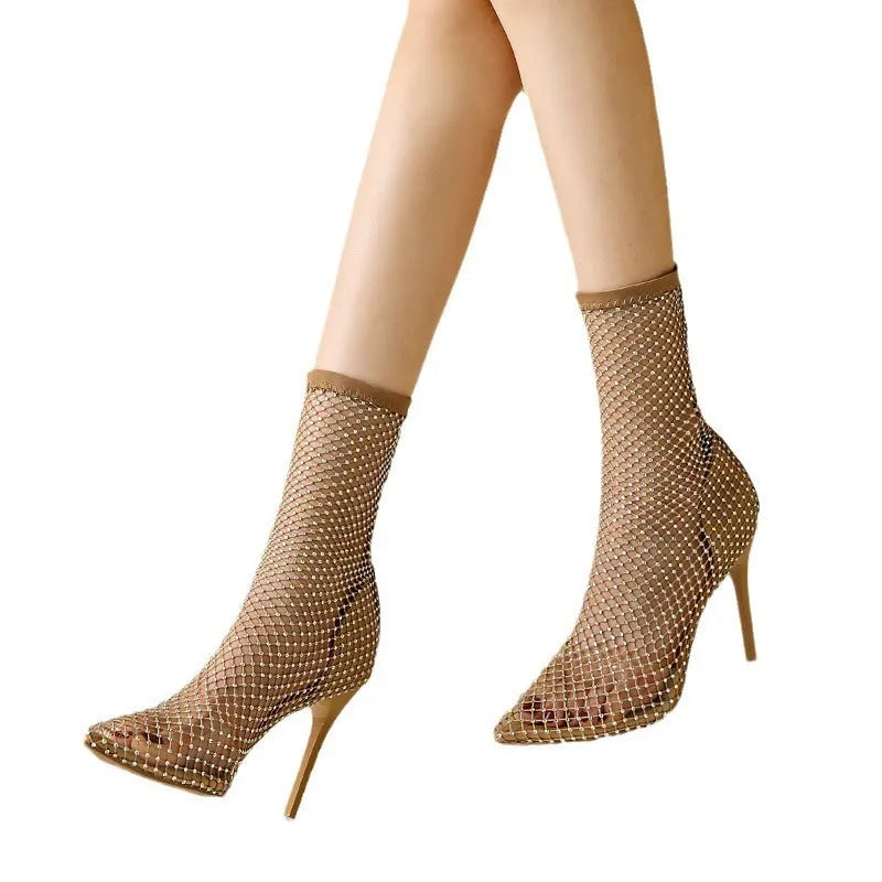 Gold high heel sandals with pointed toe, stiletto heel, mesh upper, and ankle strap.
