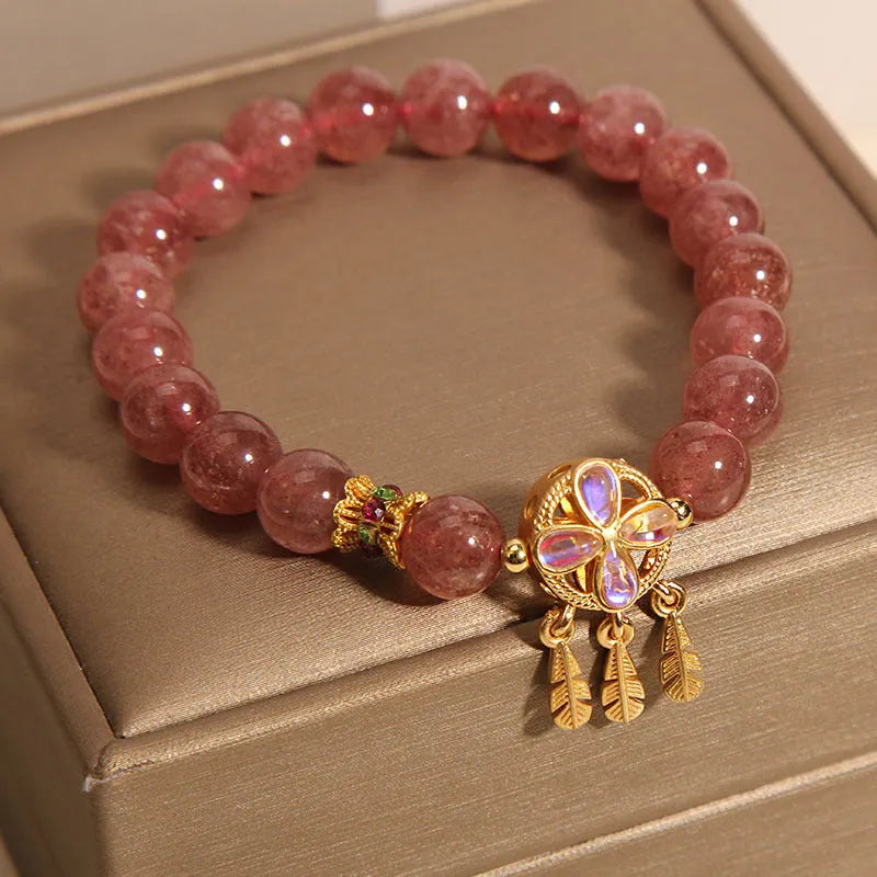 Women's strawberry quartz bracelet with four-leaf dream catcher pendant on crystal beads