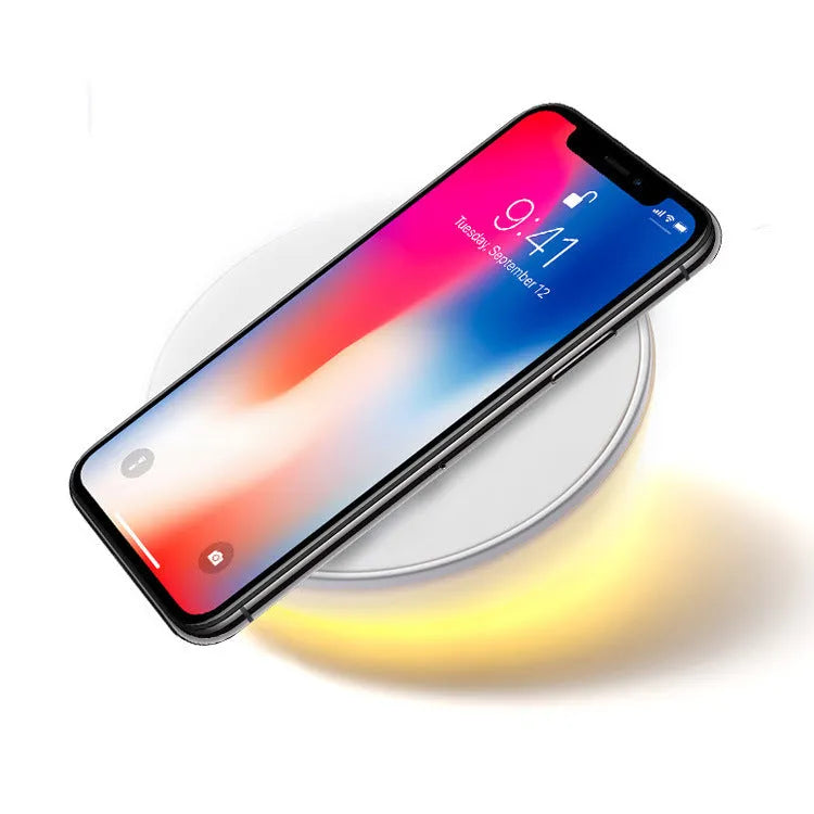 White slim QI wireless charger with LED clock display for mobile phones.