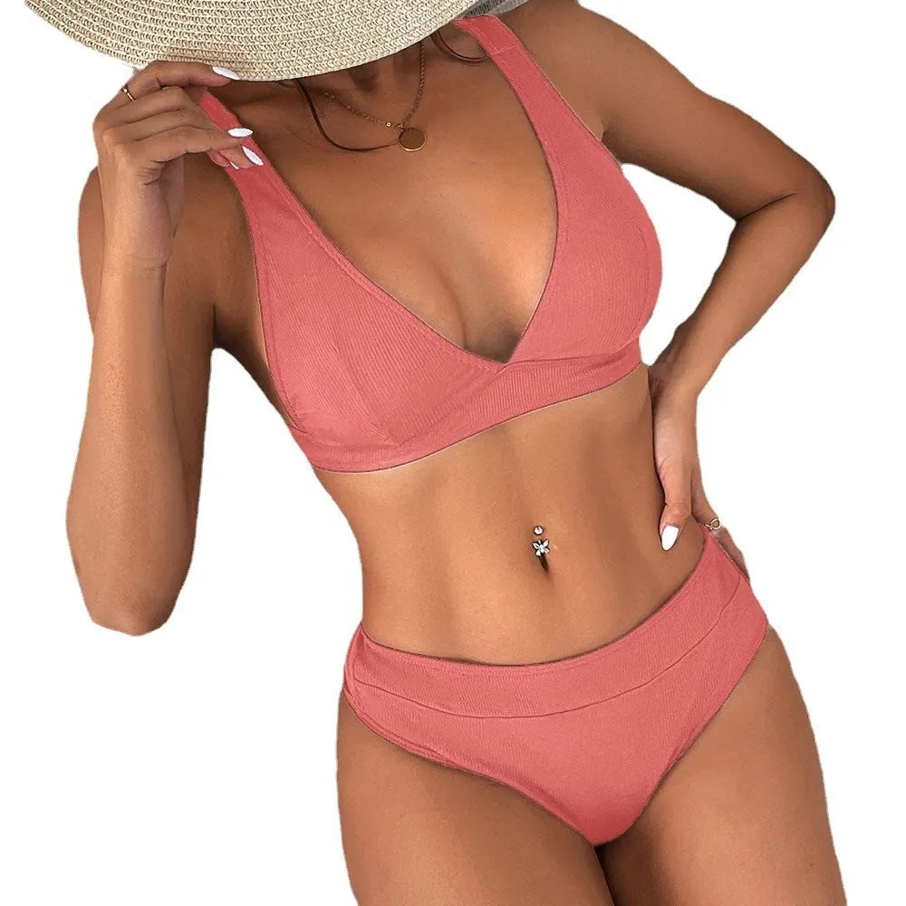 Women's black lace-up front bikini with high-leg split design on a mannequin.