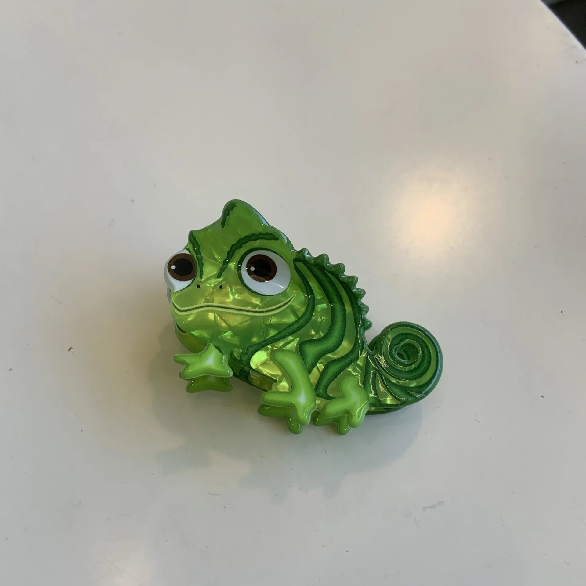Dinosaur-themed acrylic jaw hair clip showing detailed dinosaur design and secure grip mechanism