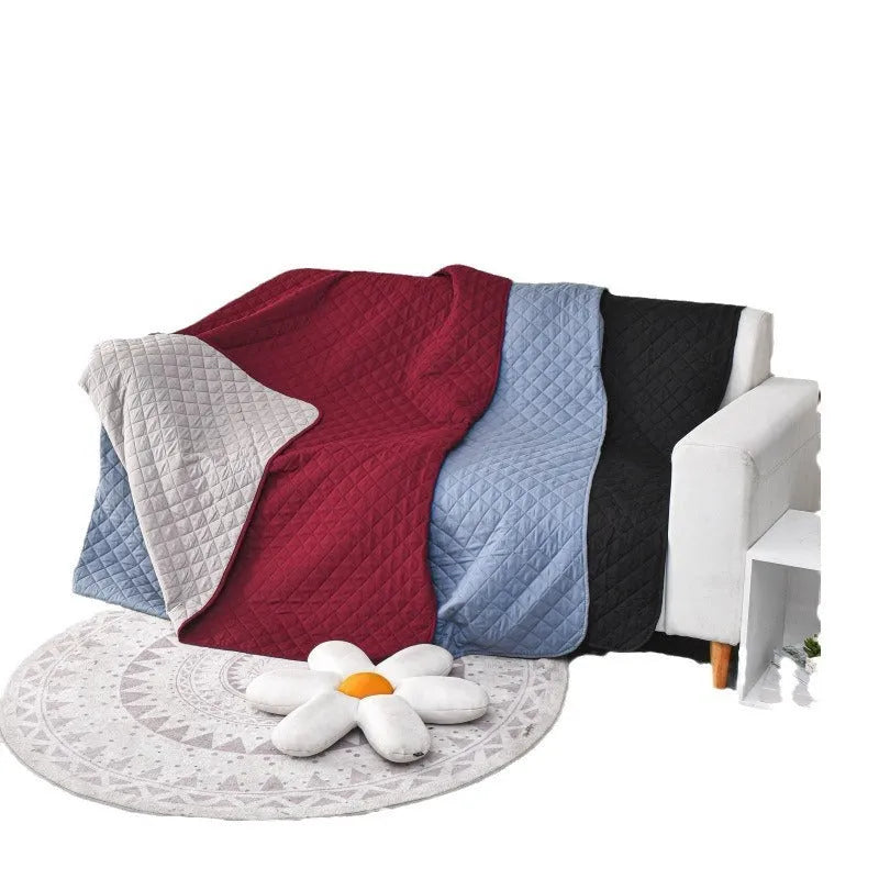 Reversible waterproof dog blanket couch cover in burgundy and grey, laid flat on a sofa.