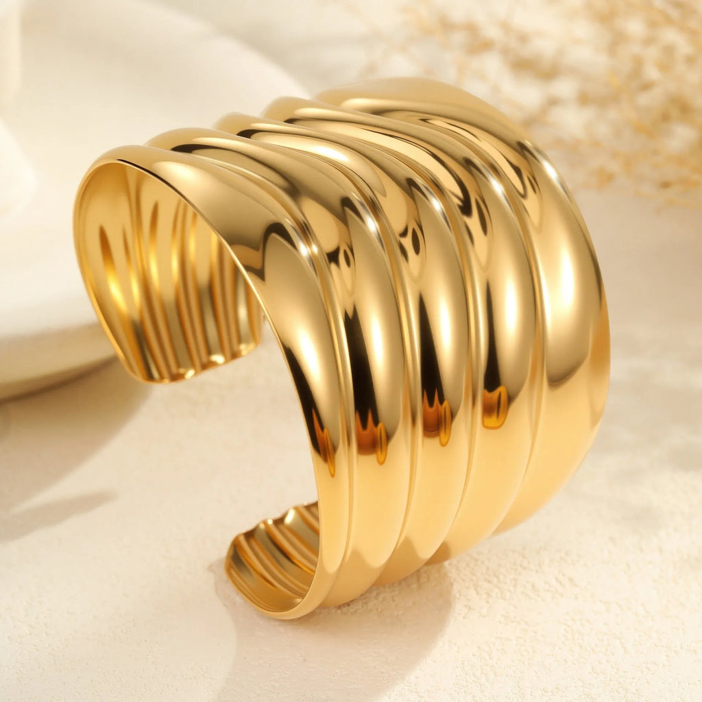 Women's fashion bracelet with exaggerated width, geometric wave patterns, and gold plating