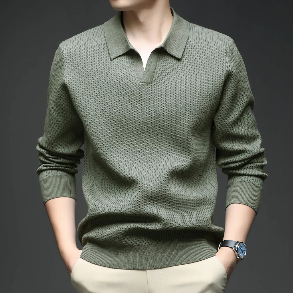 Man wearing a loose green pullover sweater, a casual autumn bottoming layer.