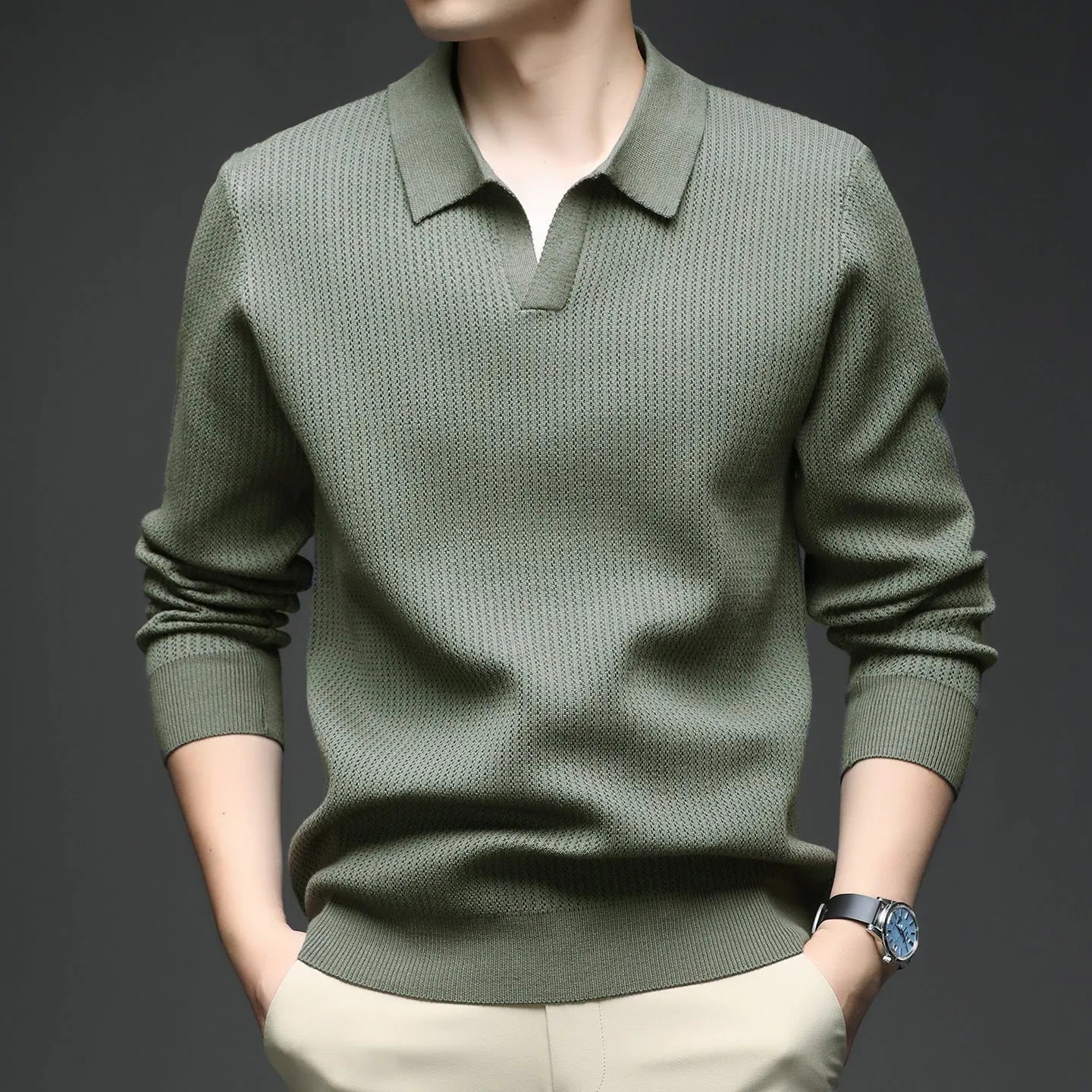 Man wearing a loose green pullover sweater, a casual autumn bottoming layer.
