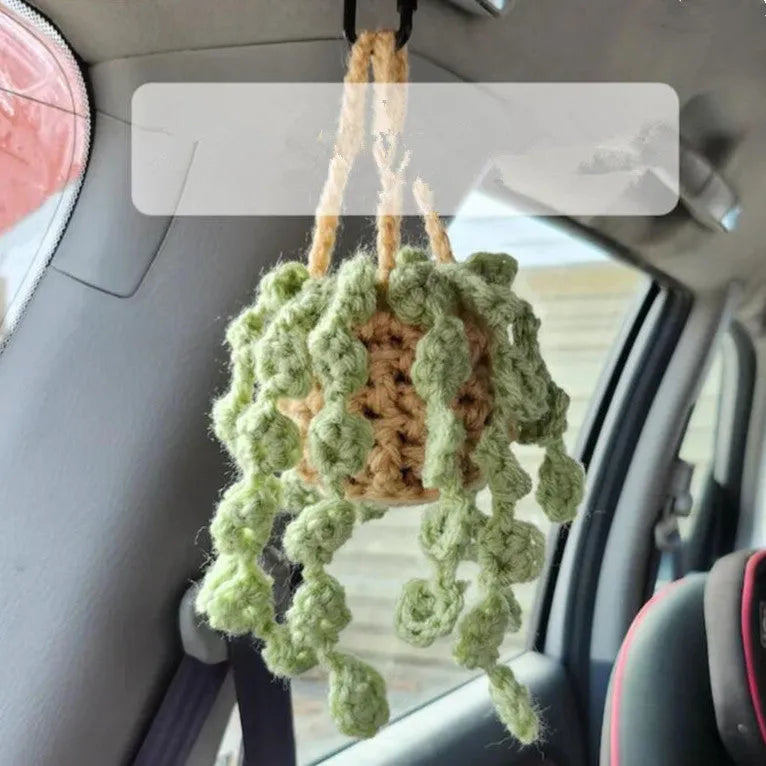 Green and white fish-scale style knitted wool car hanging planter with 8cm base and long white cord.
