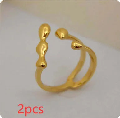 Brass opening ring in gold or silver finish with spherical design details.