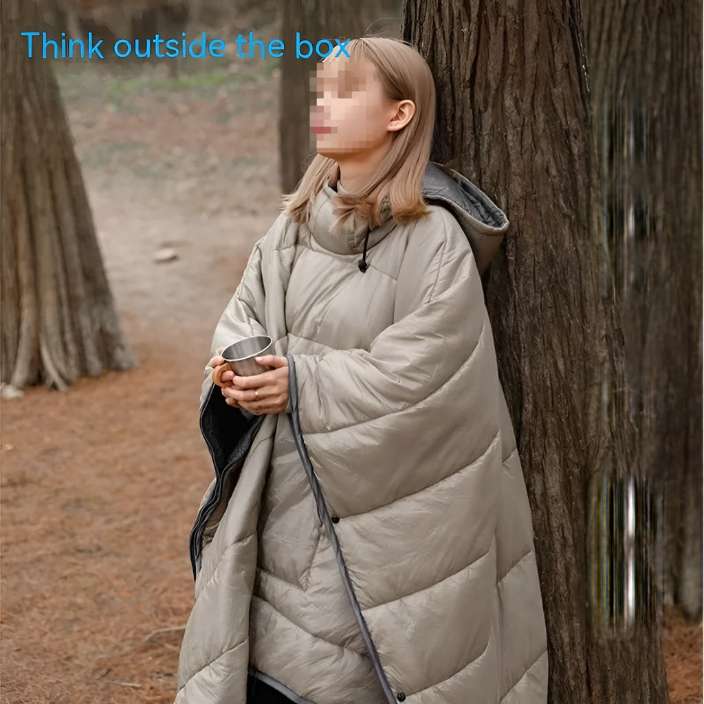 Adult-sized grey outdoor cloak sleeping bag with waterproof nylon exterior shown in wearable cape configuration