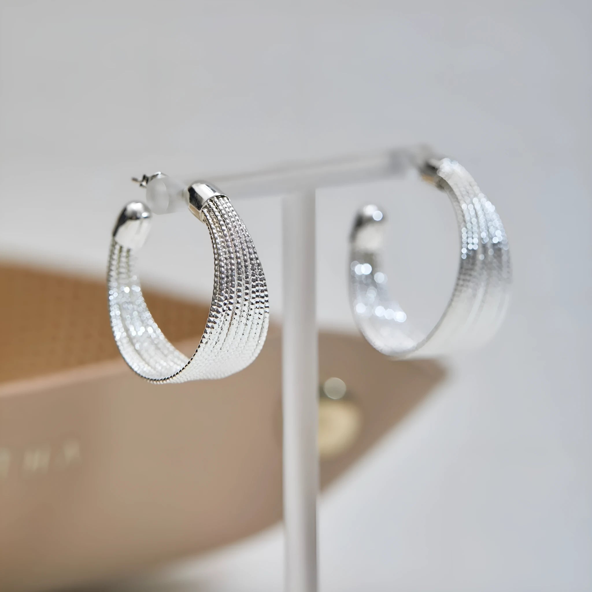 Simple geometric bracelet earrings with clip and stud backs in silver or gold colour.