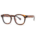 Simple round rim retro sunglasses on a plain background showing bright black frame with blue lenses.