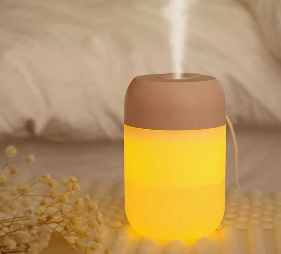 White cylindrical USB-powered mini humidifier with aromatherapy function on desk