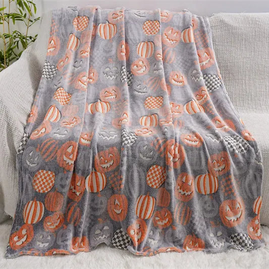 Cartoon print flannel blanket for children shown in two sizes on a bed.