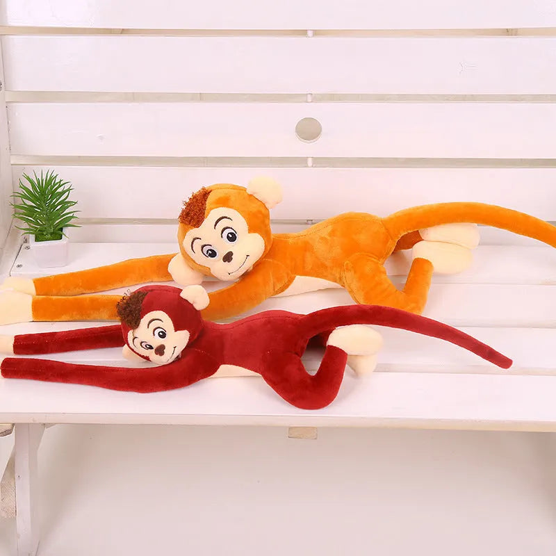 Long arm hanging monkey plush toy in pink, 70cm height, curled around a curtain rod for home decoration