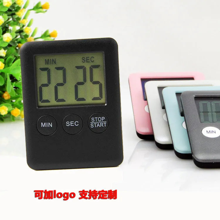 Black and white digital kitchen timer with magnet back, flip-out stand, and large LCD display.