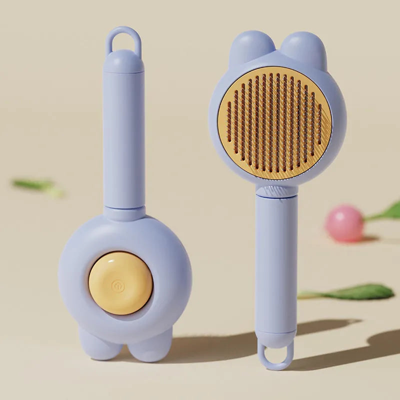 Green pet grooming brush with a self-cleaning button and a stainless steel comb.