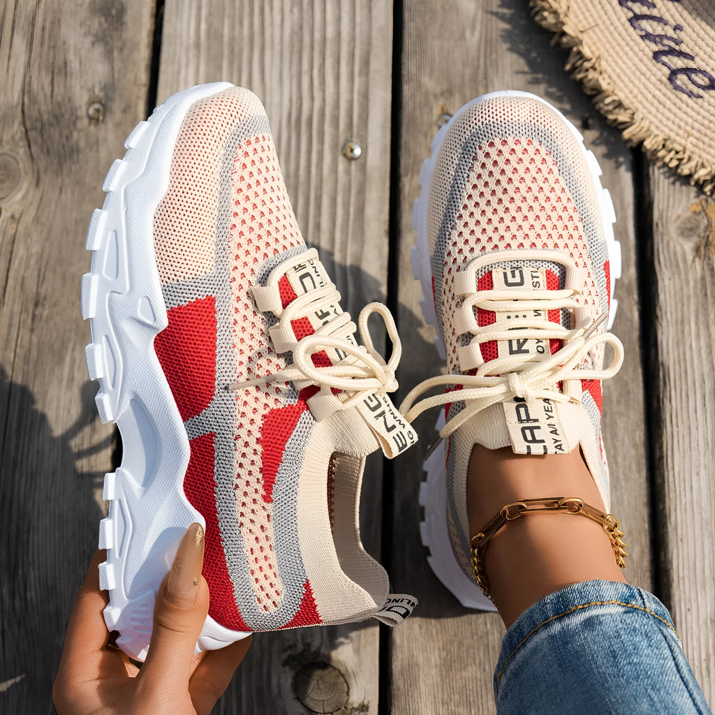 Women's Flyknit mesh lace-up sneakers in multiple colours with low flat rubber sole.