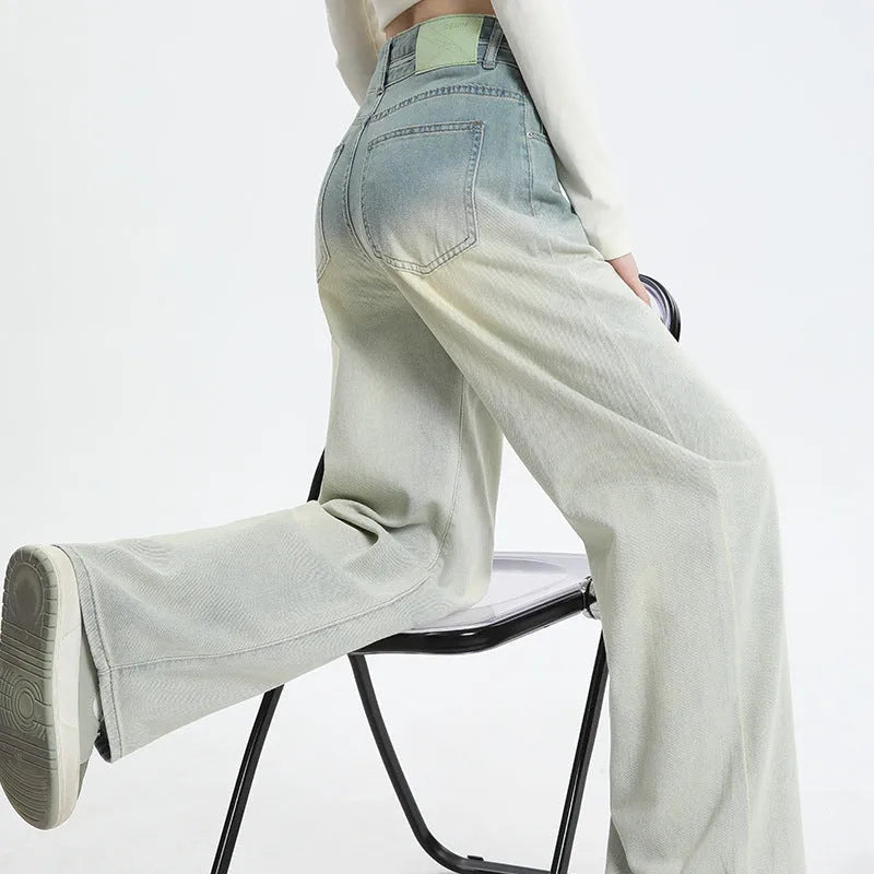 Gradient blue women's denim straight-leg trousers with a wide-leg fit on a hanger