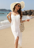White crochet suspender beach dress with thigh slit on a hanger.