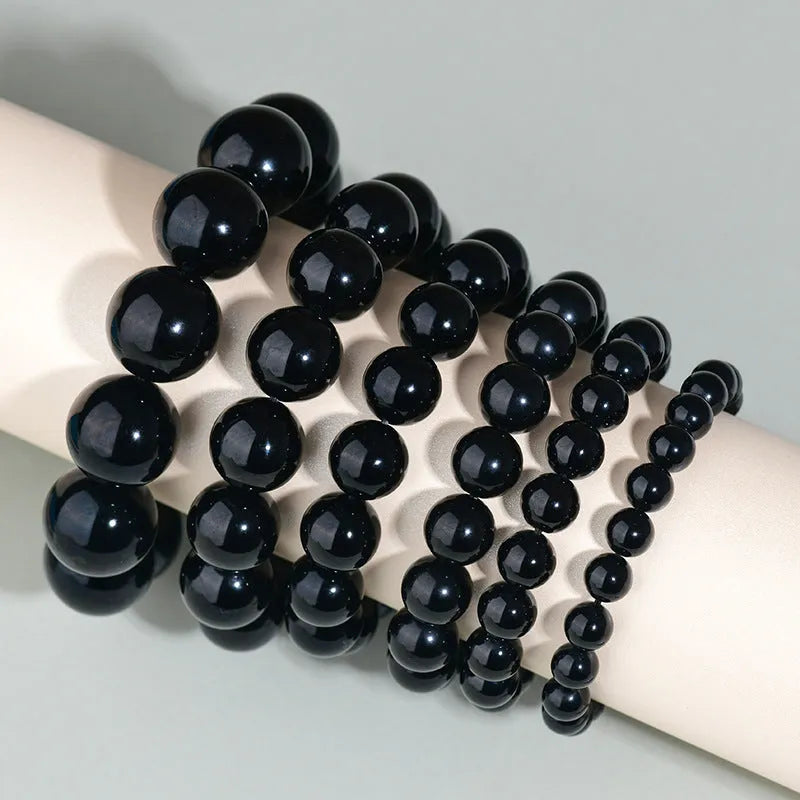 Hand-woven obsidian couples bracelet with year of birth engraving and multiple bead diameter options