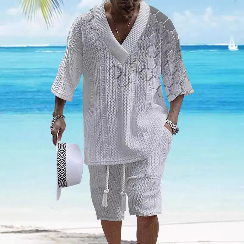 Man wearing a printed drop-shoulder knitted short-sleeve top and matching shorts in a casual setting.