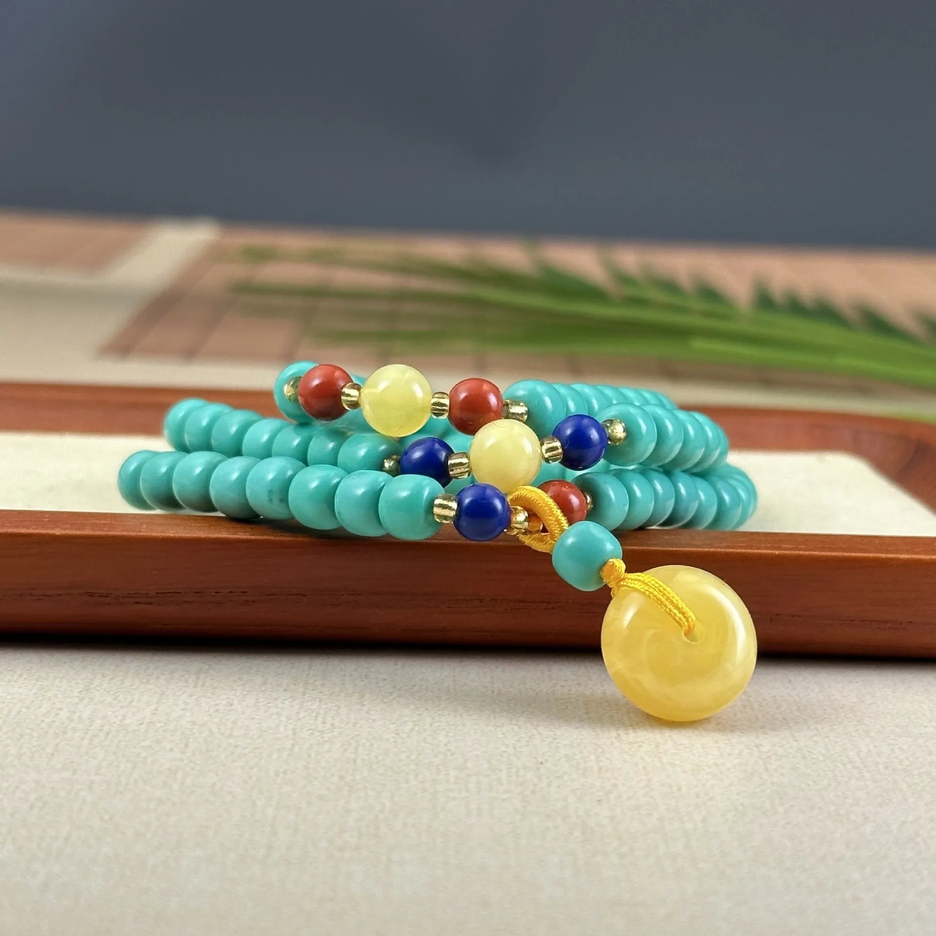 Turquoise stone pendant in hand-woven mesh flower setting on adjustable ball bead necklace chain
