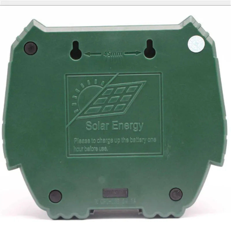 Green solar ultrasonic animal repeller unit with LED strobe lights for outdoor pest control.