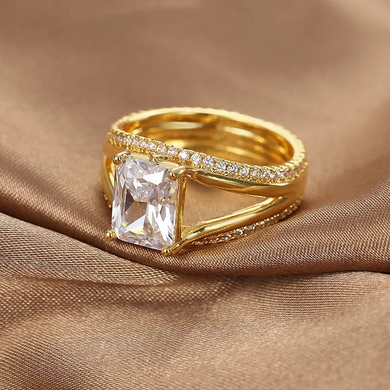 Gold electroplated copper ring with square zircon stone in geometric design, showing side profile