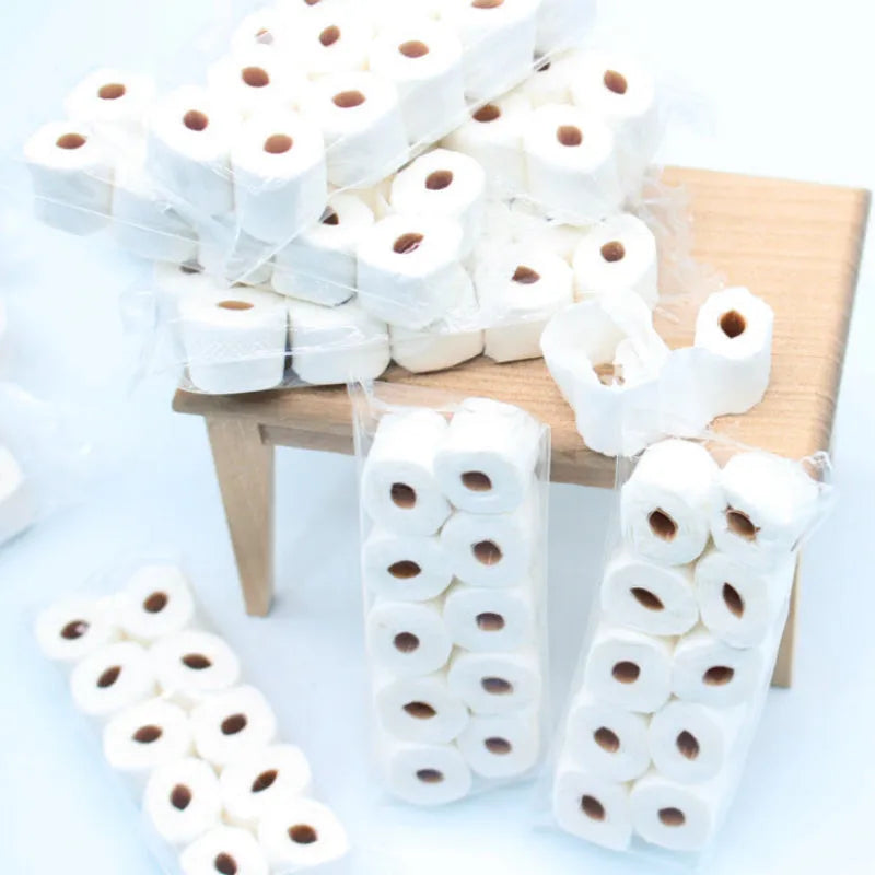 Miniature paper model of a toilet tissue roll for children's pretend play toys.