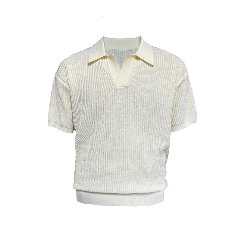Man wearing a creamy-white loose-fit polo shirt with a striped collar and short sleeves.