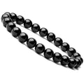 Black agate bracelet with geometric 8mm beads on a black elastic cord, laid flat.