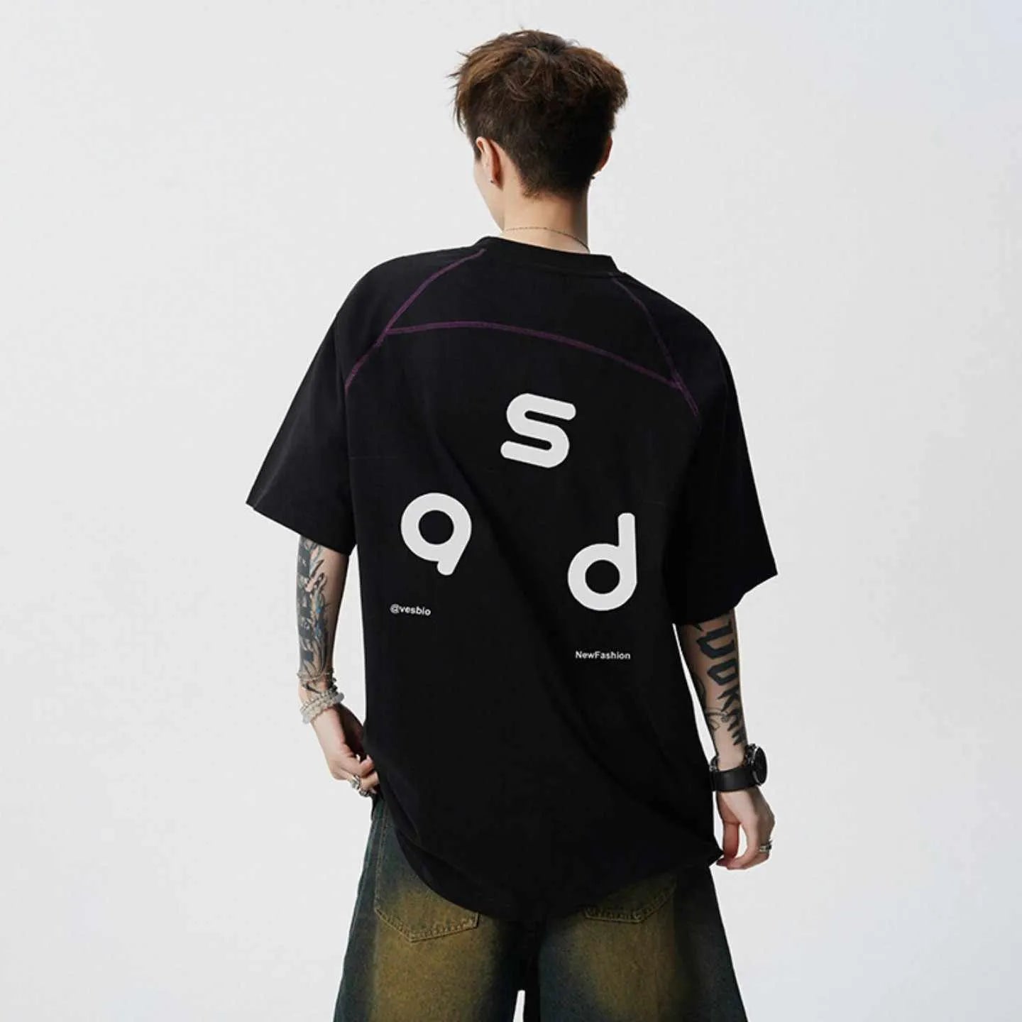 Loose fit black cotton t-shirt with white letter print, short sleeves, and round neck.