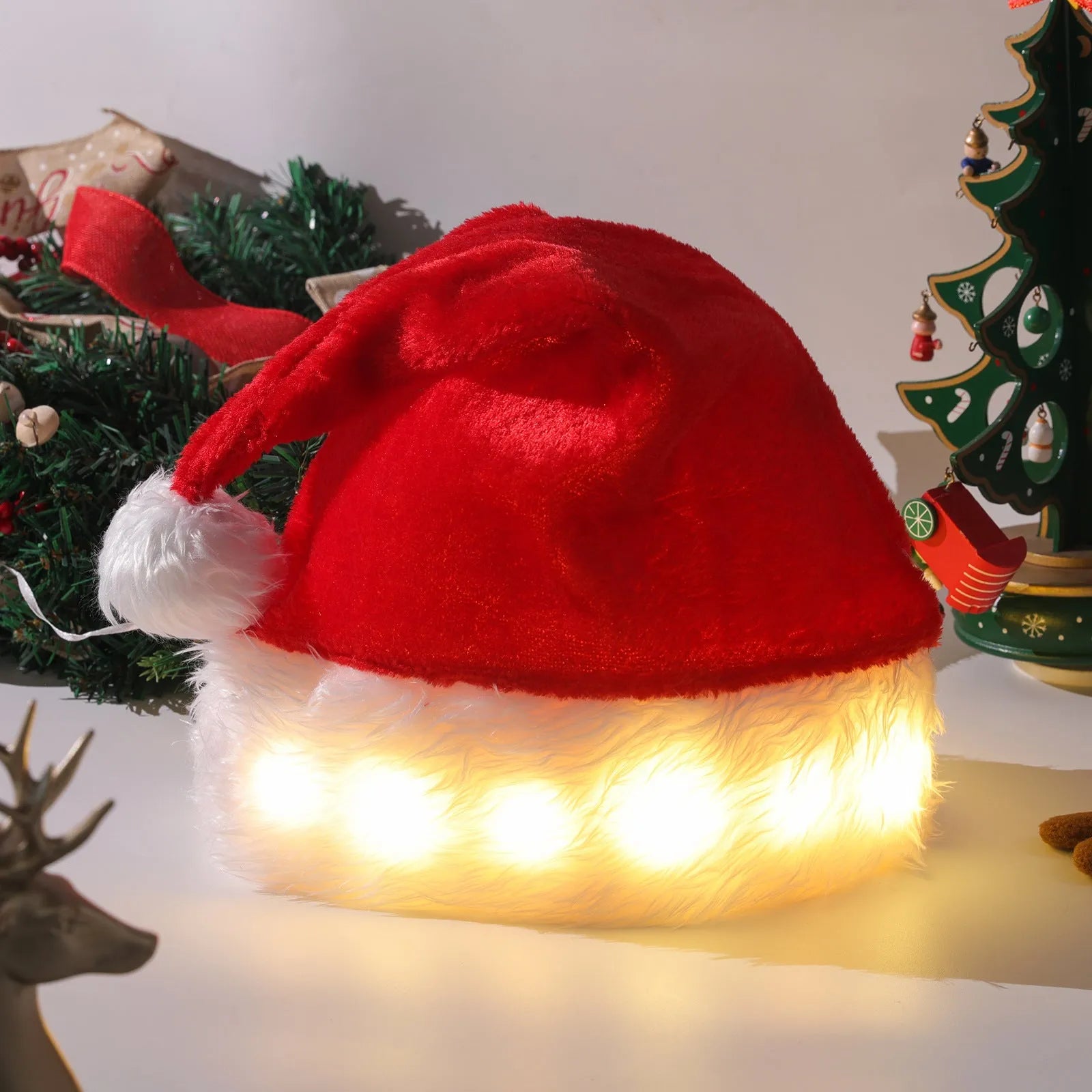Red and white plush Santa hat with pom-pom and multicolour LED lights lit up around the base.
