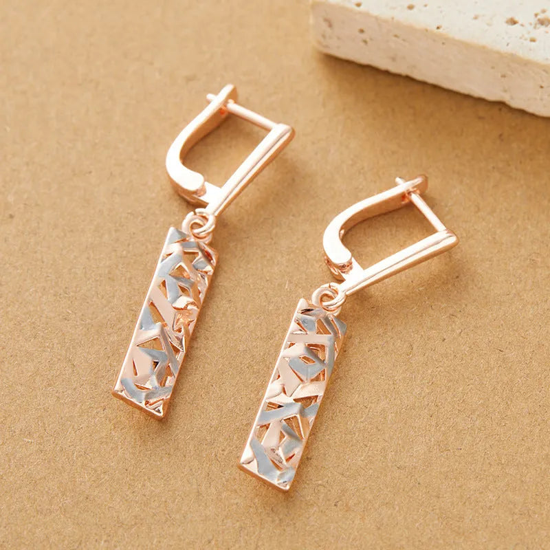 Rectangular two-tone hollow stud earrings for women with a geometric design and picture style finish.