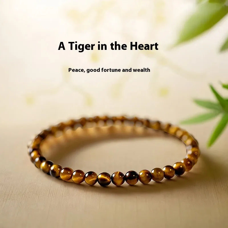 Geometric new Chinese style bracelet with round tigereye stone beads in gold and brown bands.