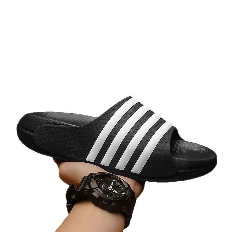 A pair of beige unisex casual sliders with a PVC upper and textured EVA sole.