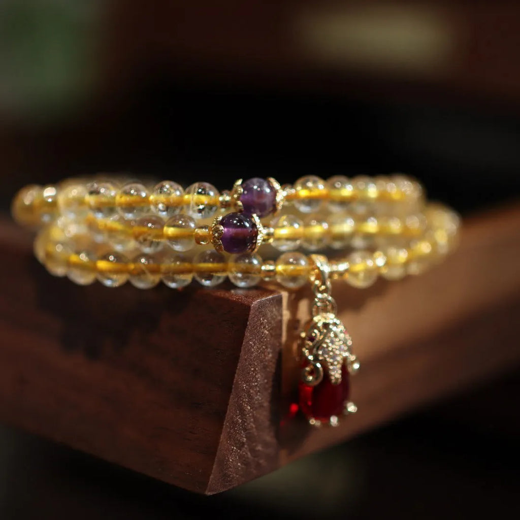 Handmade gold rutilated quartz bracelet with Chinese style design and three-circle pattern.