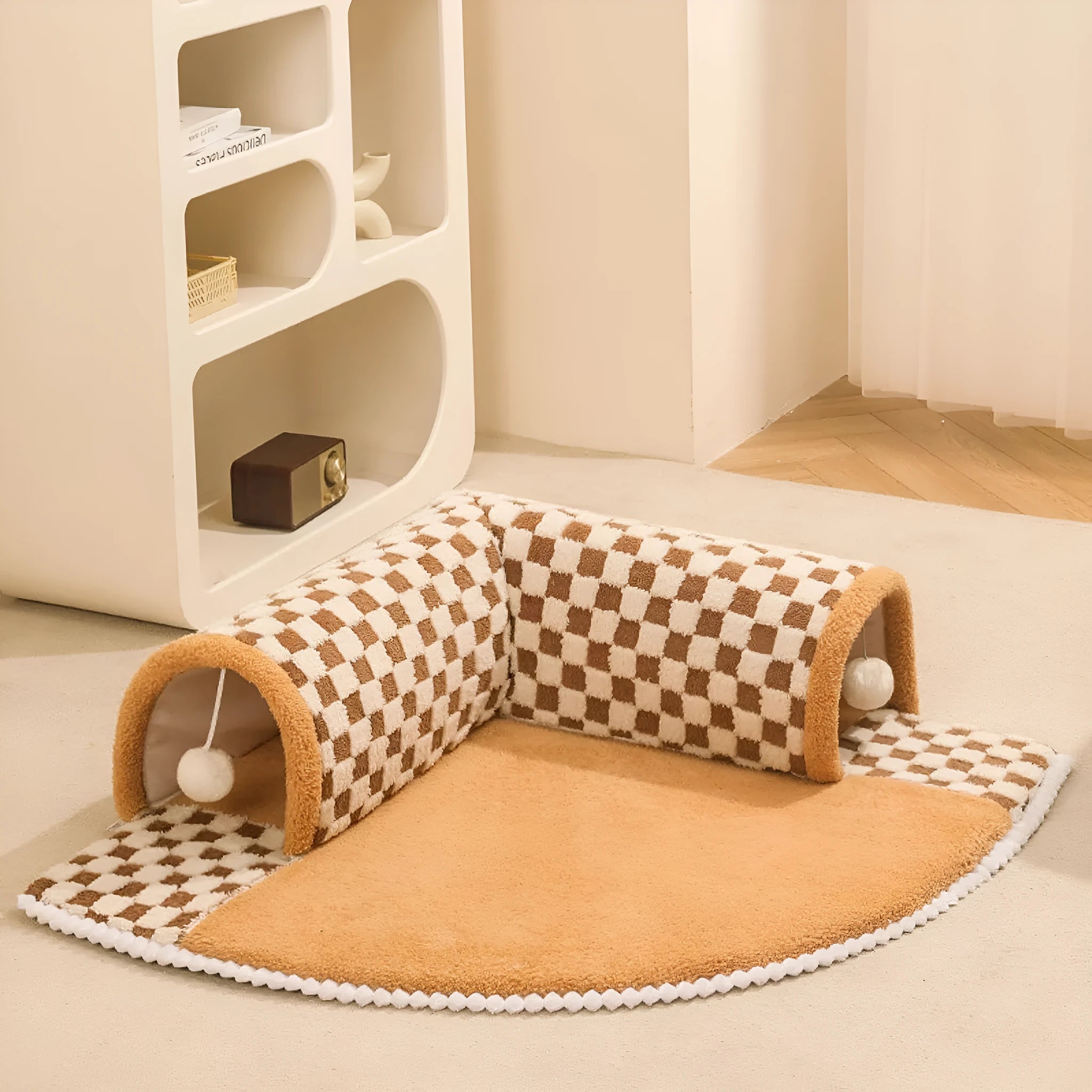 Large fan-shaped plush pet bed with attached tunnel in coffee colour on a wooden floor