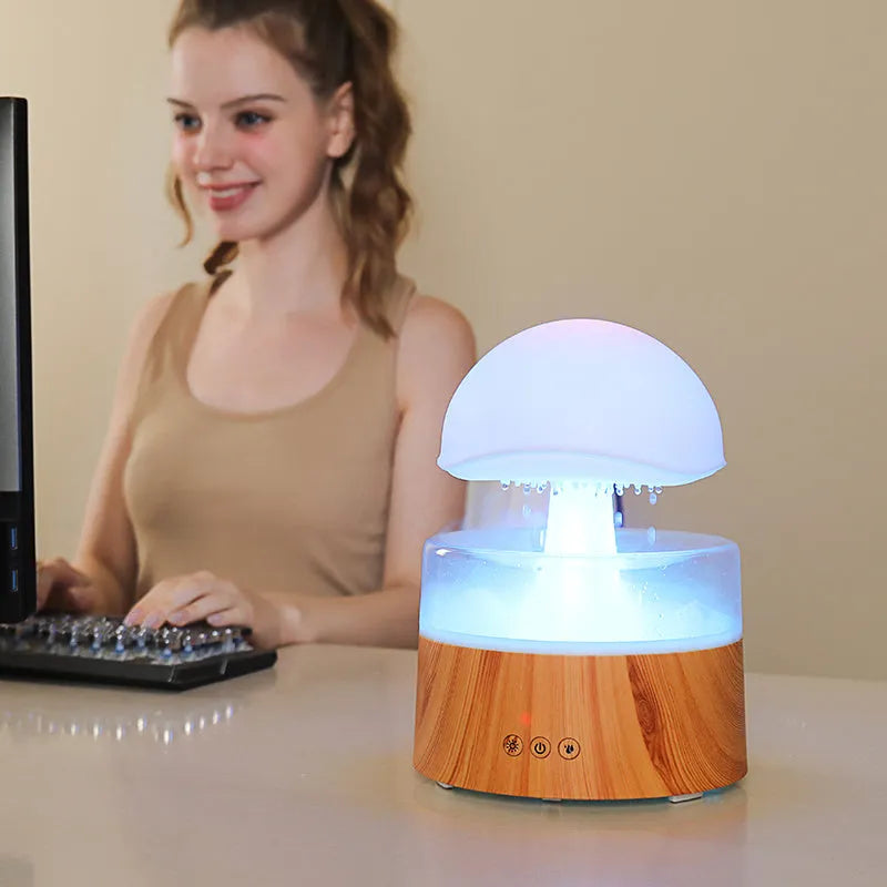 White rain cloud shaped humidifier with falling water droplets and multi-colour lighting