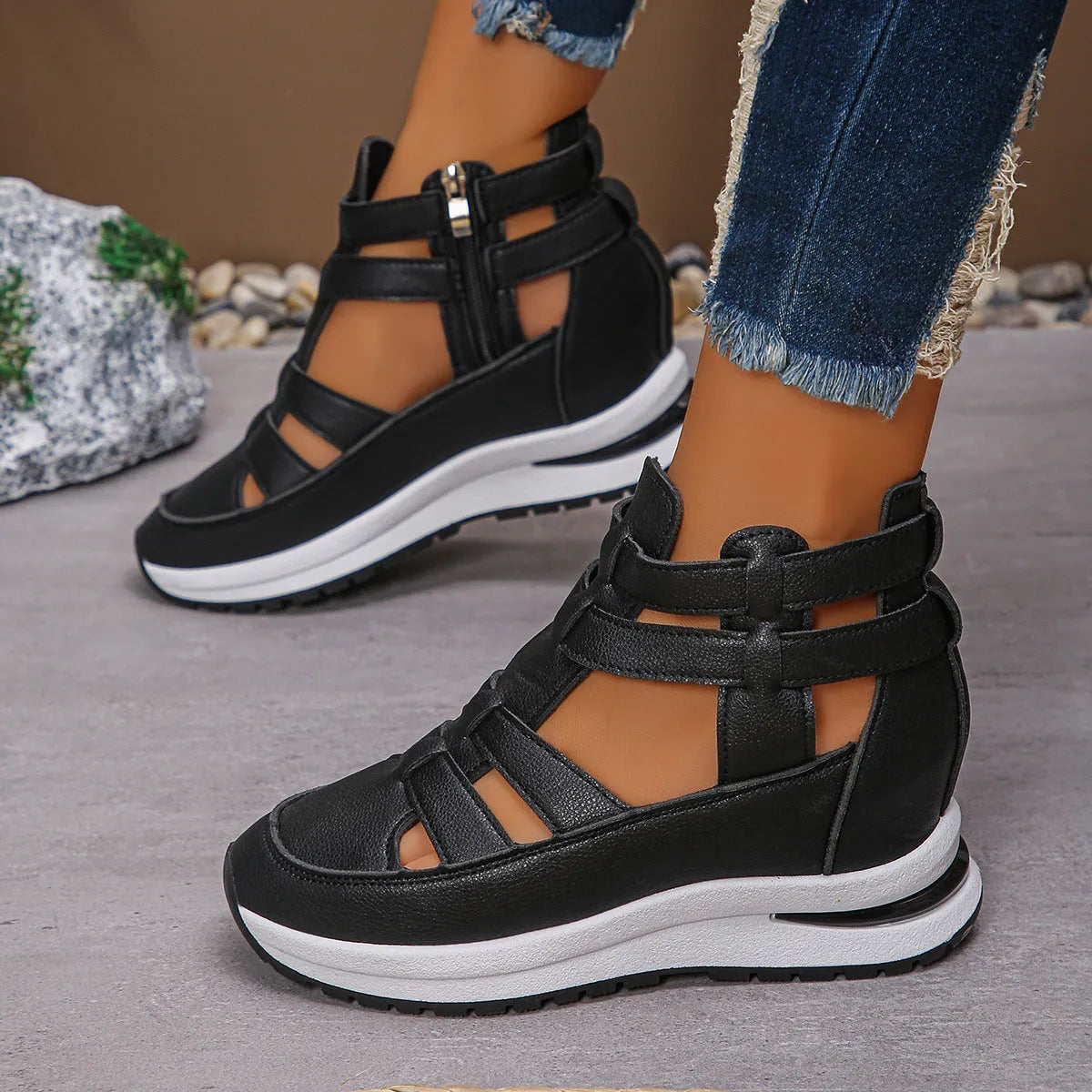 Women's black hollow-out platform sandals with Velcro fastening on a white background