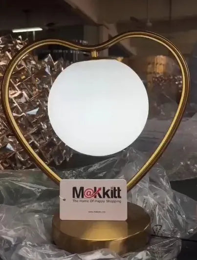 Rose gold heart-shaped decorative LED lamp on a surface