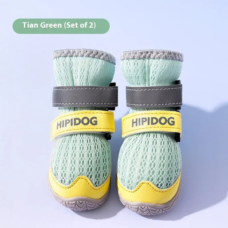 Pair of light blue cartoon-style dog shoes on a white background for summer paw protection.
