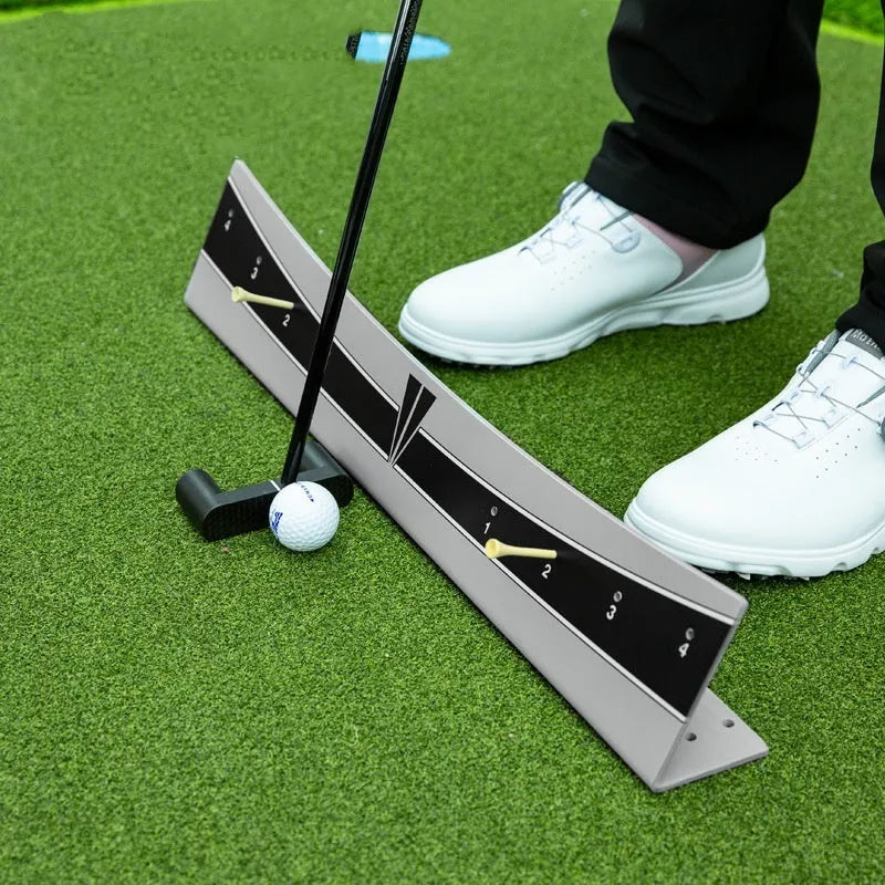 Adjustable golf putter trajectory balance simulator with PVC construction on a flat indoor surface.
